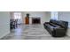 Open-concept living and dining area, featuring a fireplace and gray wood-look floors at 6357 Vicuna Dr, Las Vegas, NV 89146