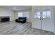 Bright living room featuring a fireplace, wood-look flooring, and double doors at 6357 Vicuna Dr, Las Vegas, NV 89146