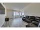 Open-concept living room with gray wood-look floors and a view into the dining area at 6357 Vicuna Dr, Las Vegas, NV 89146