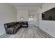 Spacious living room features modern floors, sleek TV, and elegant entry doors at 6357 Vicuna Dr, Las Vegas, NV 89146