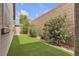 The backyard features artificial turf with desert landscaping at 660 Otter Brook St, Henderson, NV 89011
