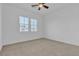 Bright bedroom with carpet, ceiling fan, and windows providing natural light at 660 Otter Brook St, Henderson, NV 89011