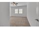 Neutral bedroom featuring two windows and a ceiling fan at 660 Otter Brook St, Henderson, NV 89011