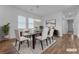 Bright dining room features a glass table, white chairs, modern lighting, and wood floors at 660 Otter Brook St, Henderson, NV 89011