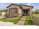 Inviting single-story home with a stone accent wall, desert landscaping, and brick walkway at 660 Otter Brook St, Henderson, NV 89011