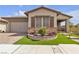 Charming single-story home with a stone facade, desert landscaping, and inviting front porch at 660 Otter Brook St, Henderson, NV 89011