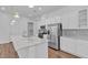 Bright kitchen with white cabinetry, stainless steel appliances, and wood-look flooring at 660 Otter Brook St, Henderson, NV 89011