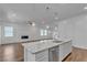 Modern kitchen featuring white cabinets, stainless steel appliances, and granite countertops at 660 Otter Brook St, Henderson, NV 89011