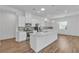 Open kitchen featuring white cabinets, stainless steel appliances, and a large island at 660 Otter Brook St, Henderson, NV 89011