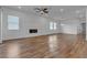 Spacious living room featuring a fireplace, ceiling fan, and wood floors at 660 Otter Brook St, Henderson, NV 89011