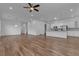 Spacious living room featuring a fireplace, ceiling fan, and wood floors at 660 Otter Brook St, Henderson, NV 89011