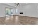Living room features a fireplace, ceiling fan, sliding glass door and wood floors at 660 Otter Brook St, Henderson, NV 89011