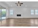 Bright living room featuring a fireplace, ceiling fan, and wood floors at 660 Otter Brook St, Henderson, NV 89011