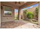 Covered patio area with brick flooring, wall, and garden landscaping, creating a private outdoor space at 660 Otter Brook St, Henderson, NV 89011