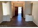 Bright foyer with wood-look tile floors and an elegant hanging light fixture at 6632 Coastal Breeze Ct, Las Vegas, NV 89108