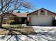 Charming single-story home with a well-manicured lawn and attached two car garage at 6632 Coastal Breeze Ct, Las Vegas, NV 89108