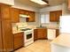 Traditional kitchen with white appliances, wood cabinetry, and plenty of counter space at 6632 Coastal Breeze Ct, Las Vegas, NV 89108