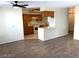 Open kitchen with bright white appliances, breakfast bar, and wood look tile flooring at 6632 Coastal Breeze Ct, Las Vegas, NV 89108