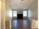 Inviting living room featuring wood-look tile floors, a fireplace, and plenty of natural light at 6632 Coastal Breeze Ct, Las Vegas, NV 89108