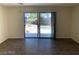 Living room featuring wood-look tile floors and sliding glass doors to the backyard at 6632 Coastal Breeze Ct, Las Vegas, NV 89108