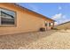 Back exterior features gravel, desert landscaping, and a covered patio at 665 Look Lively Ct, Henderson, NV 89011