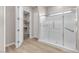 Bathroom showcasing large glass enclosed shower, safety bars, and open door to walk-in closet at 665 Look Lively Ct, Henderson, NV 89011