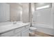Bright bathroom features a single sink vanity, toilet, and shower/tub with white subway tile at 665 Look Lively Ct, Henderson, NV 89011
