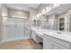 Bright bathroom with a glass-enclosed shower, double sinks, and modern fixtures at 665 Look Lively Ct, Henderson, NV 89011