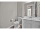 Powder room featuring white toilet and sink with vanity, and neutral colored walls at 665 Look Lively Ct, Henderson, NV 89011