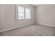 Light-filled bedroom features double windows, carpet floors, and neutral walls, creating a cozy and inviting space at 665 Look Lively Ct, Henderson, NV 89011