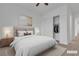 A staged bedroom showcasing the bed, lighting, art and closet, combining comfort and style in a tranquil setting at 665 Look Lively Ct, Henderson, NV 89011