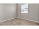 Bright bedroom with natural light showcasing laminated floor, freshly painted neutral walls and baseboards at 665 Look Lively Ct, Henderson, NV 89011