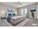 Staged bedroom with plush bedding, stylish decor, a ceiling fan, and carpeted floors at 665 Look Lively Ct, Henderson, NV 89011