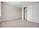 This bedroom features neutral carpet, white trim, and a closet, offering a blend of comfort and practicality at 665 Look Lively Ct, Henderson, NV 89011
