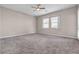 Large, empty bedroom with neutral paint, carpeted floors, and a ceiling fan at 665 Look Lively Ct, Henderson, NV 89011