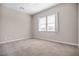 This bright bedroom features a double window, neutral carpet, and freshly painted walls, creating a cozy and inviting space at 665 Look Lively Ct, Henderson, NV 89011