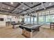 Billiard room with tables, unique ceiling design, bar seating and large windows at 665 Look Lively Ct, Henderson, NV 89011