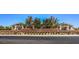 Exterior view of the clubhouse, featuring mature landscaping, brick accent walls, and covered entrances at 665 Look Lively Ct, Henderson, NV 89011