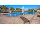 Large community pool featuring sun loungers, tables, and lounge chairs at 665 Look Lively Ct, Henderson, NV 89011