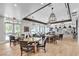 Bright dining area with round tables, comfortable chairs, and pendant lighting at 665 Look Lively Ct, Henderson, NV 89011