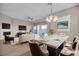 Dining area with elegant lighting, a view of the living room and sliding door to patio at 665 Look Lively Ct, Henderson, NV 89011