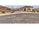 A tan single-story home with desert landscaping on a cul-de-sac at 665 Look Lively Ct, Henderson, NV 89011