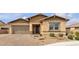 Charming single-story home with a two-car garage and desert landscaping at 665 Look Lively Ct, Henderson, NV 89011