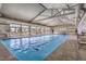Indoor community pool features ample natural light, marked swim lanes and adjacent seating at 665 Look Lively Ct, Henderson, NV 89011