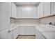 Bright laundry room with white cabinets, laminate counters, washer, dryer, and sink at 665 Look Lively Ct, Henderson, NV 89011