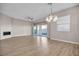 Spacious living room featuring a modern fireplace, stylish chandelier, and sliding glass doors at 665 Look Lively Ct, Henderson, NV 89011