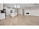 Spacious living area with a modern kitchen, ample natural light, and hardwood floors at 665 Look Lively Ct, Henderson, NV 89011