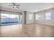 Bright living room with sliding glass doors, modern ceiling fan, and great natural light at 665 Look Lively Ct, Henderson, NV 89011