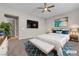 Staged primary bedroom with stylish decor, a ceiling fan, and carpeted floors at 665 Look Lively Ct, Henderson, NV 89011