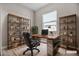This staged home office features a sleek desk, comfortable seating, and shelving for organized, stylish remote work at 665 Look Lively Ct, Henderson, NV 89011
